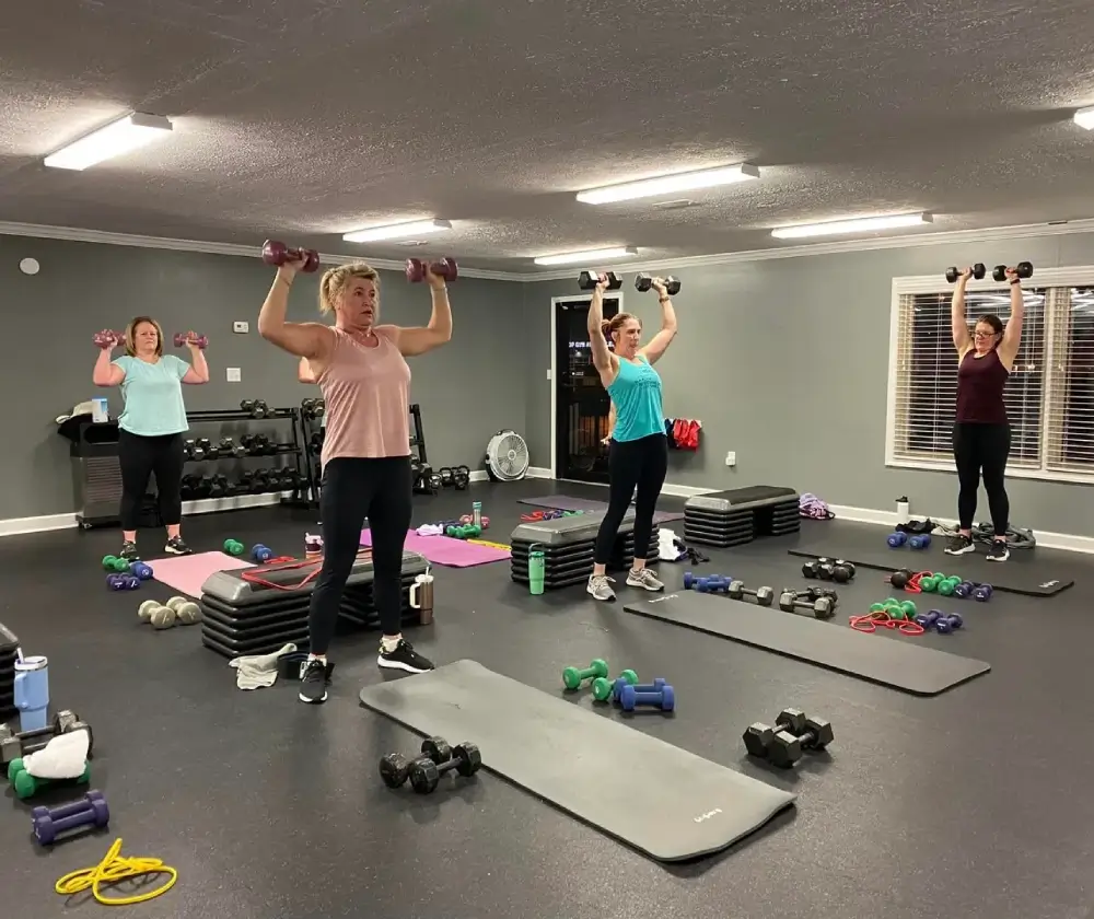 A group of people in a gym doing exercises.