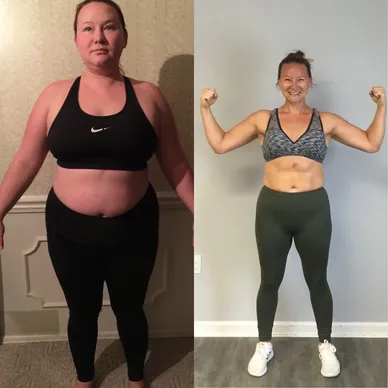 A woman is standing in front of the wall and then she has her arms up.