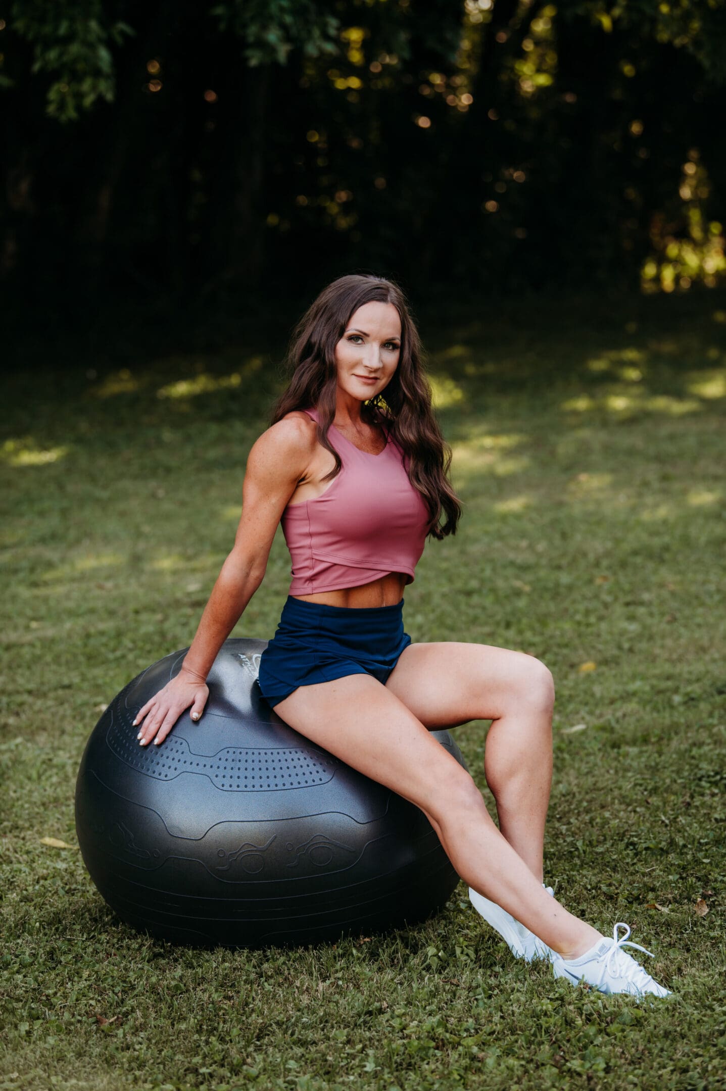 A woman sitting on top of an exercise ball.